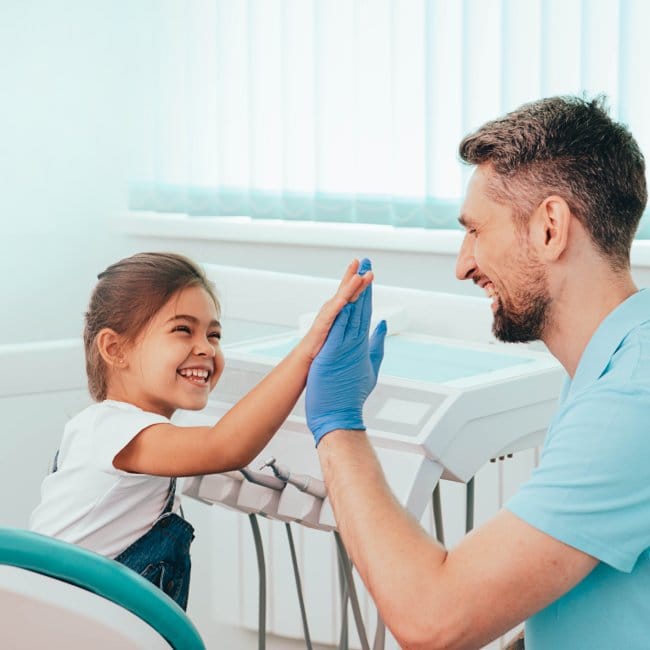 man smiling in dentists chair